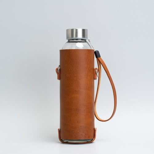 Leather water bottle holder with strap and glass bottle